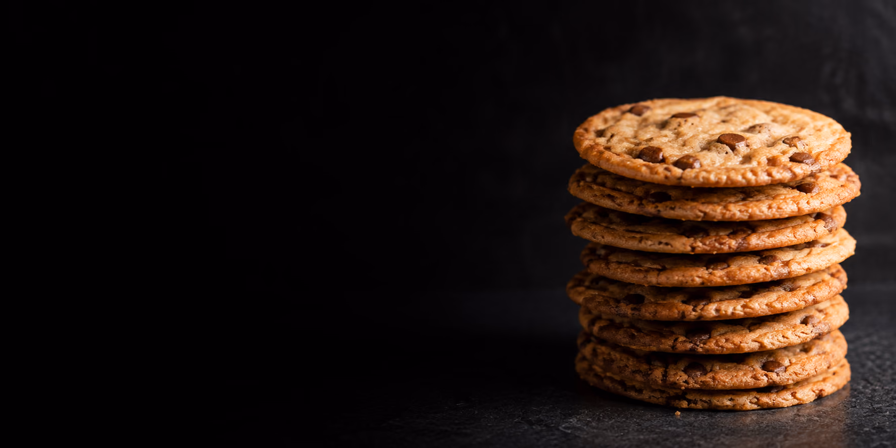 A stack of Otterbein's Cookies on a dark surface